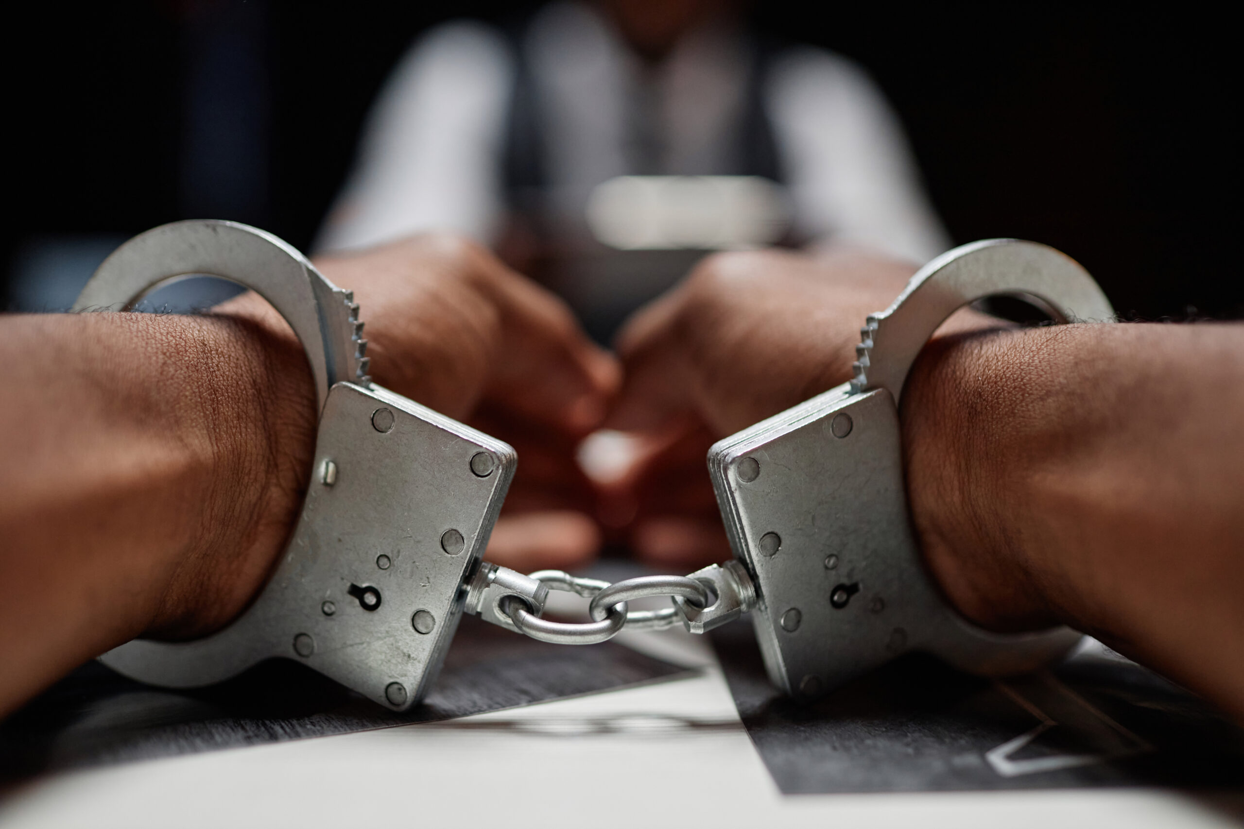 closeup of person's hands in handcuffs