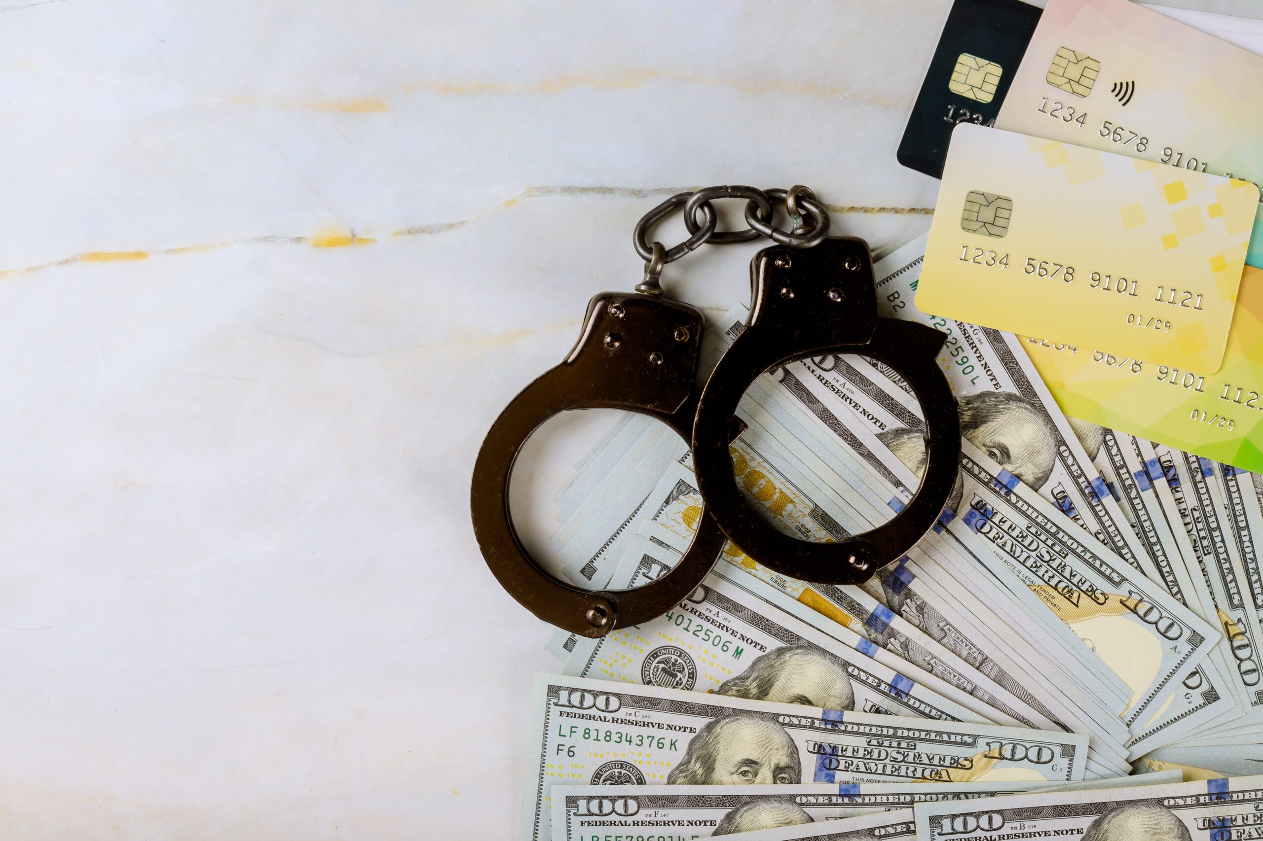 handcuffs with credit cards and money